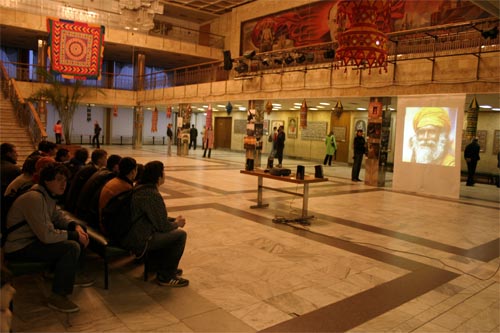 view of part of exhibition in Zaporozhye, with video projector on the right side. Many people were attracted with multimedia shows and video films about India.